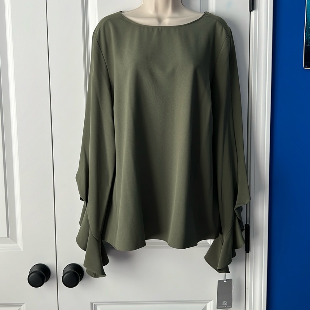 NWT. Soft green blouse with ruffle like sleeves